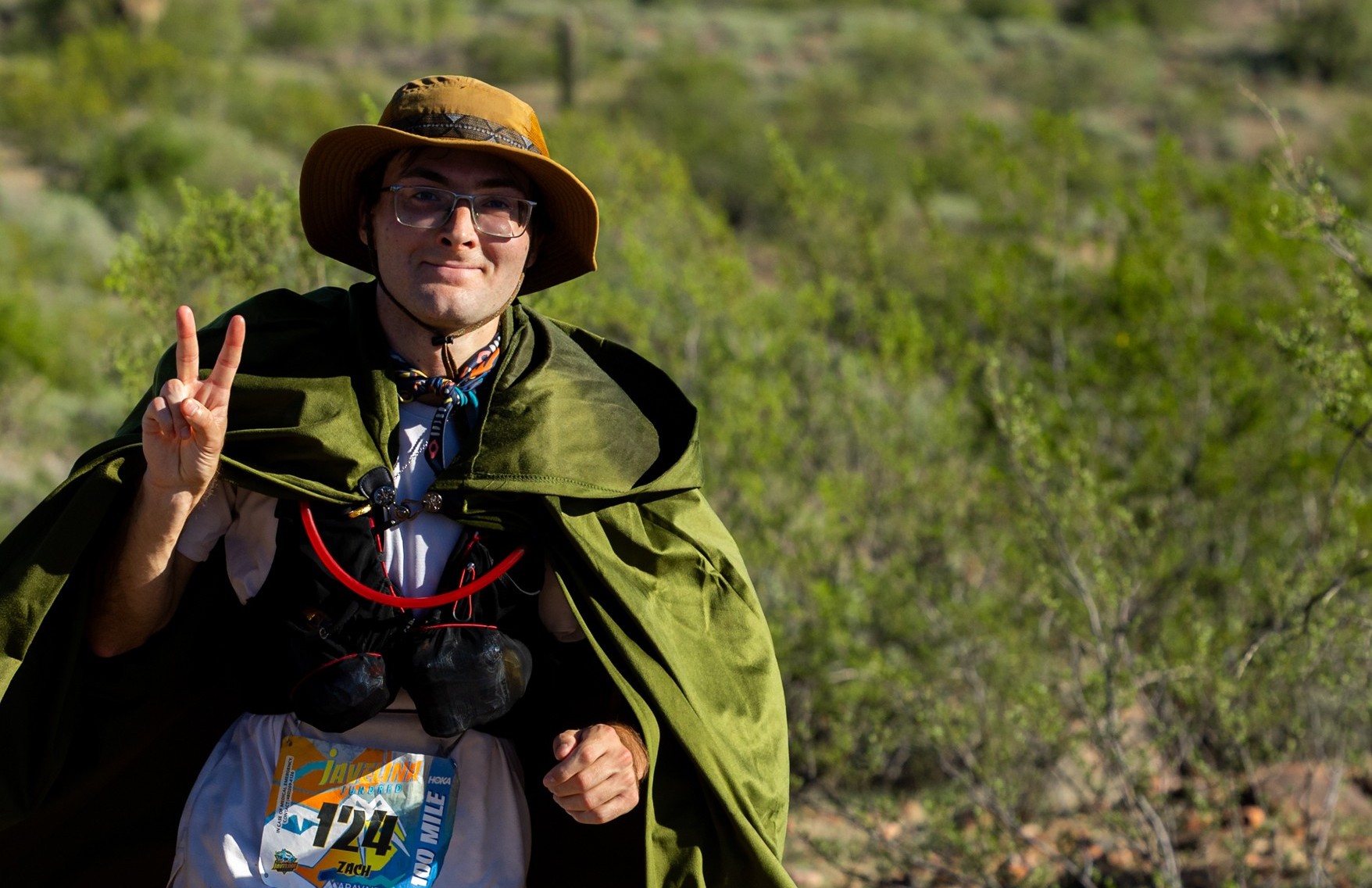 Zach running in the desert in a Frodo cape at the 2025 Javeline Jundred