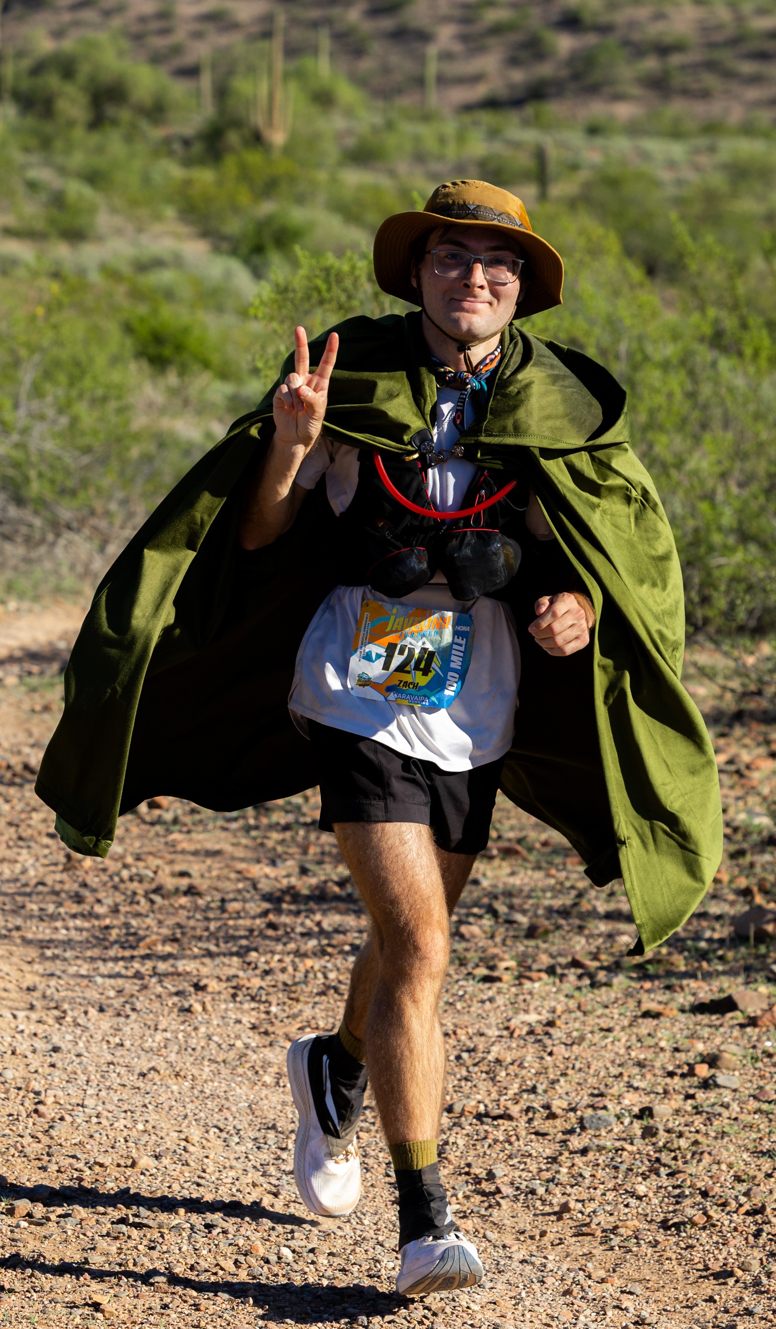Zach running in the desert in a Frodo cape at the 2025 Javeline Jundred